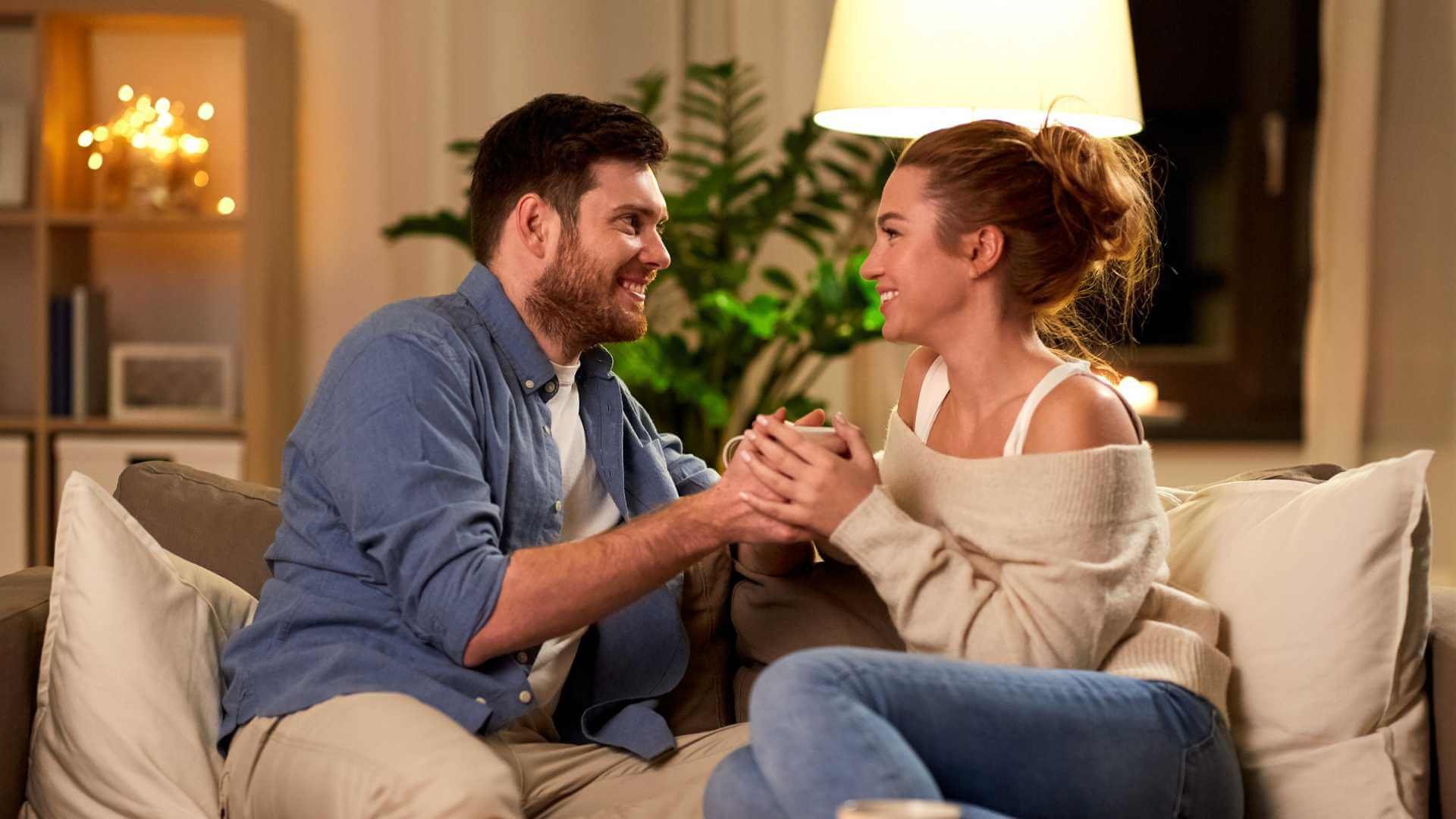 Man and woman relaxing on sofa.