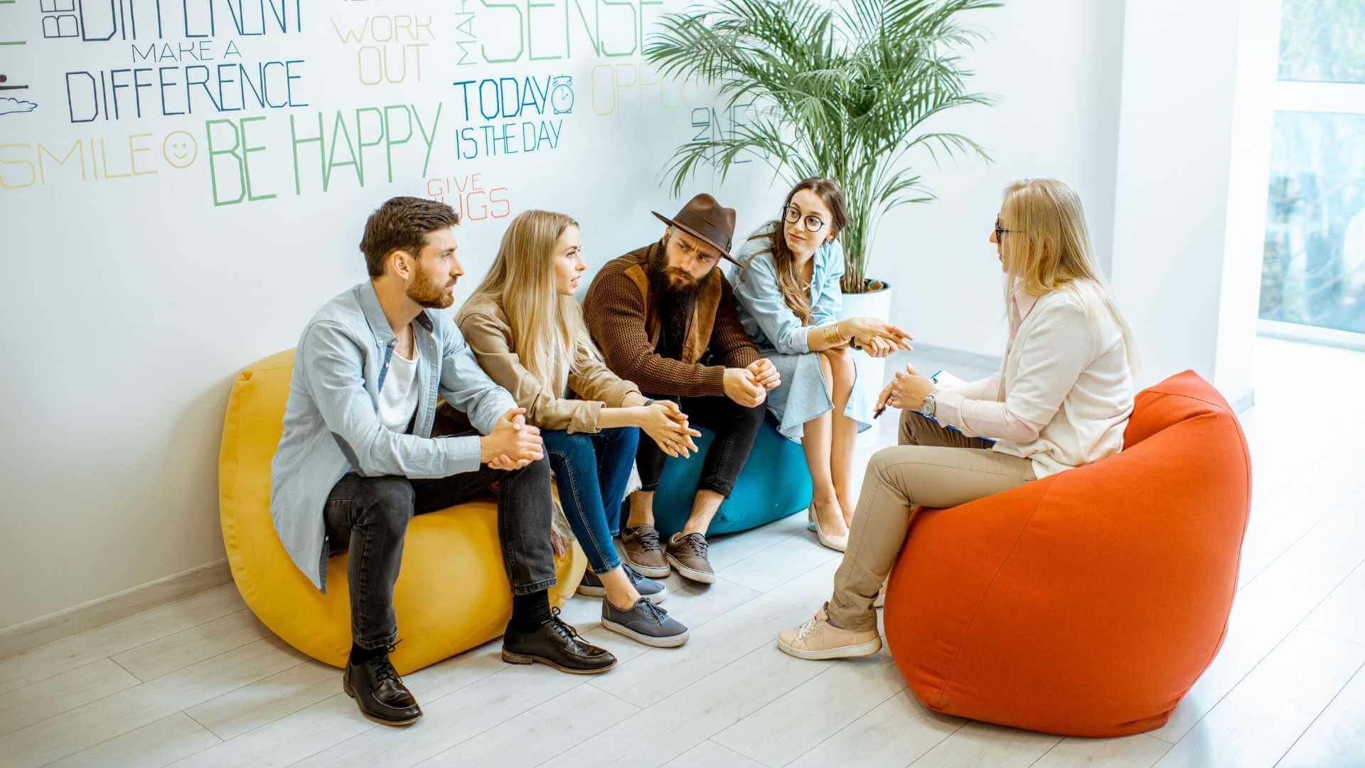 People sitting on bean bags in office.