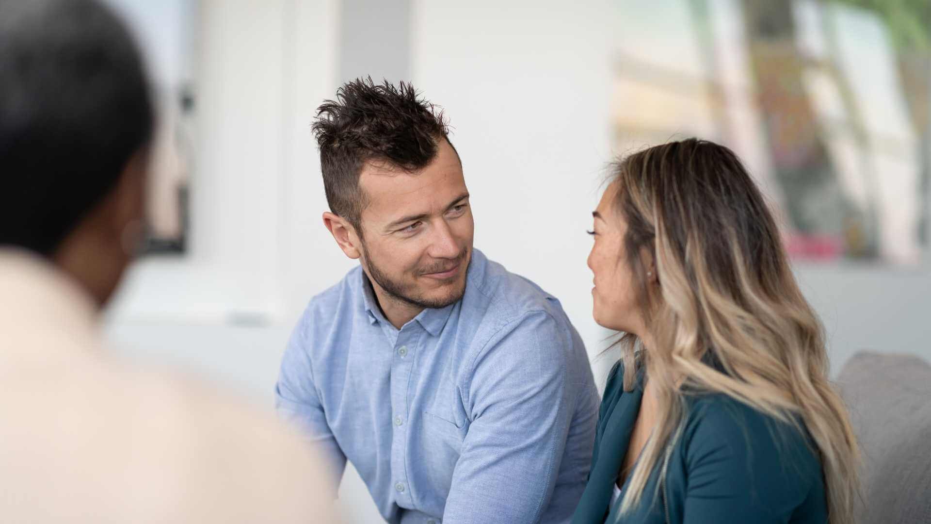A man and woman discussing in an office.
